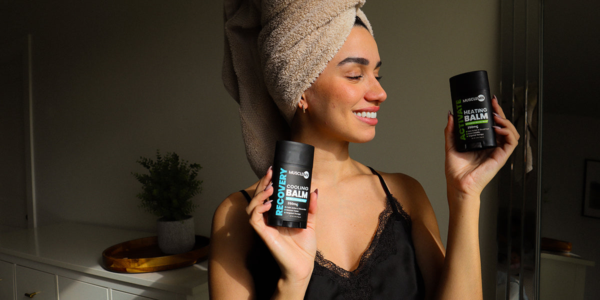 Woman holding Muscle MX Balms